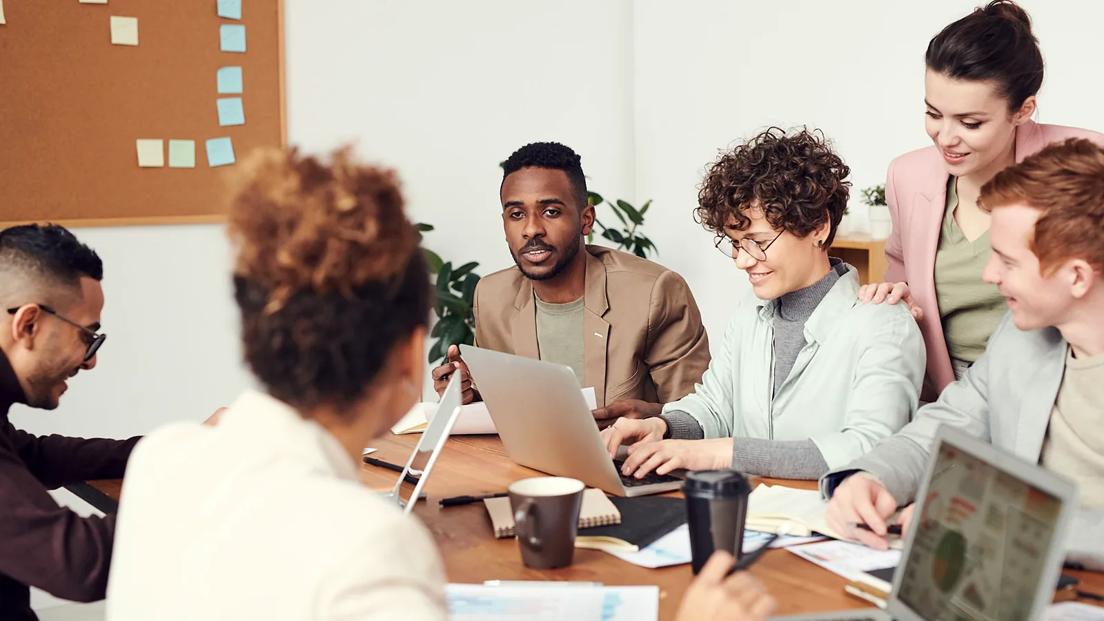 Colleagues discussing work in a bright meeting room