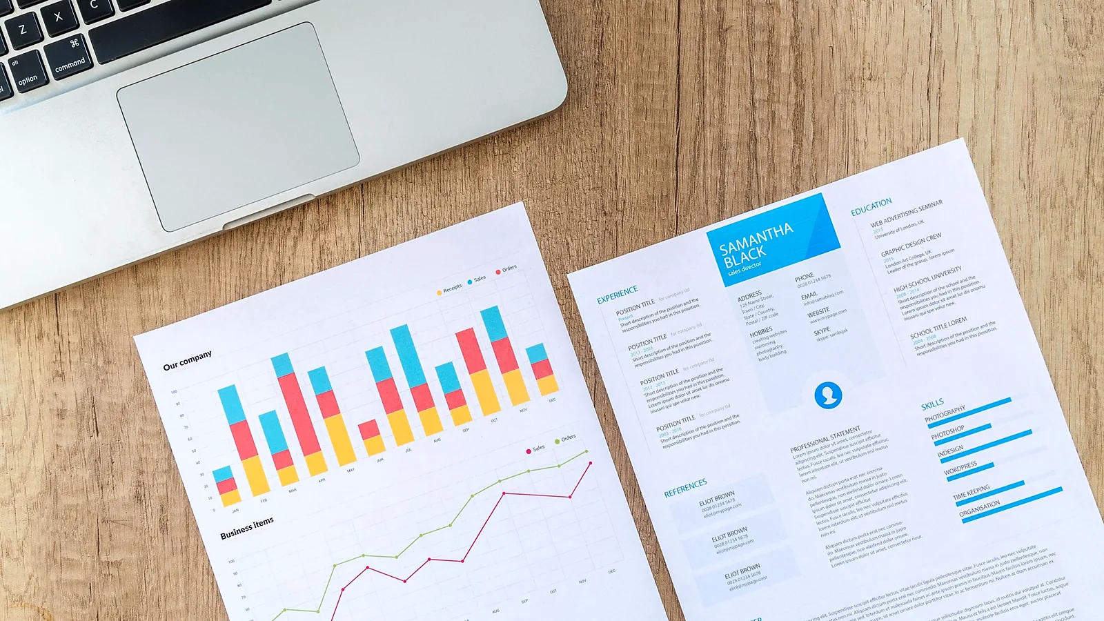 A desk with printed reports, a notebook and a calculator