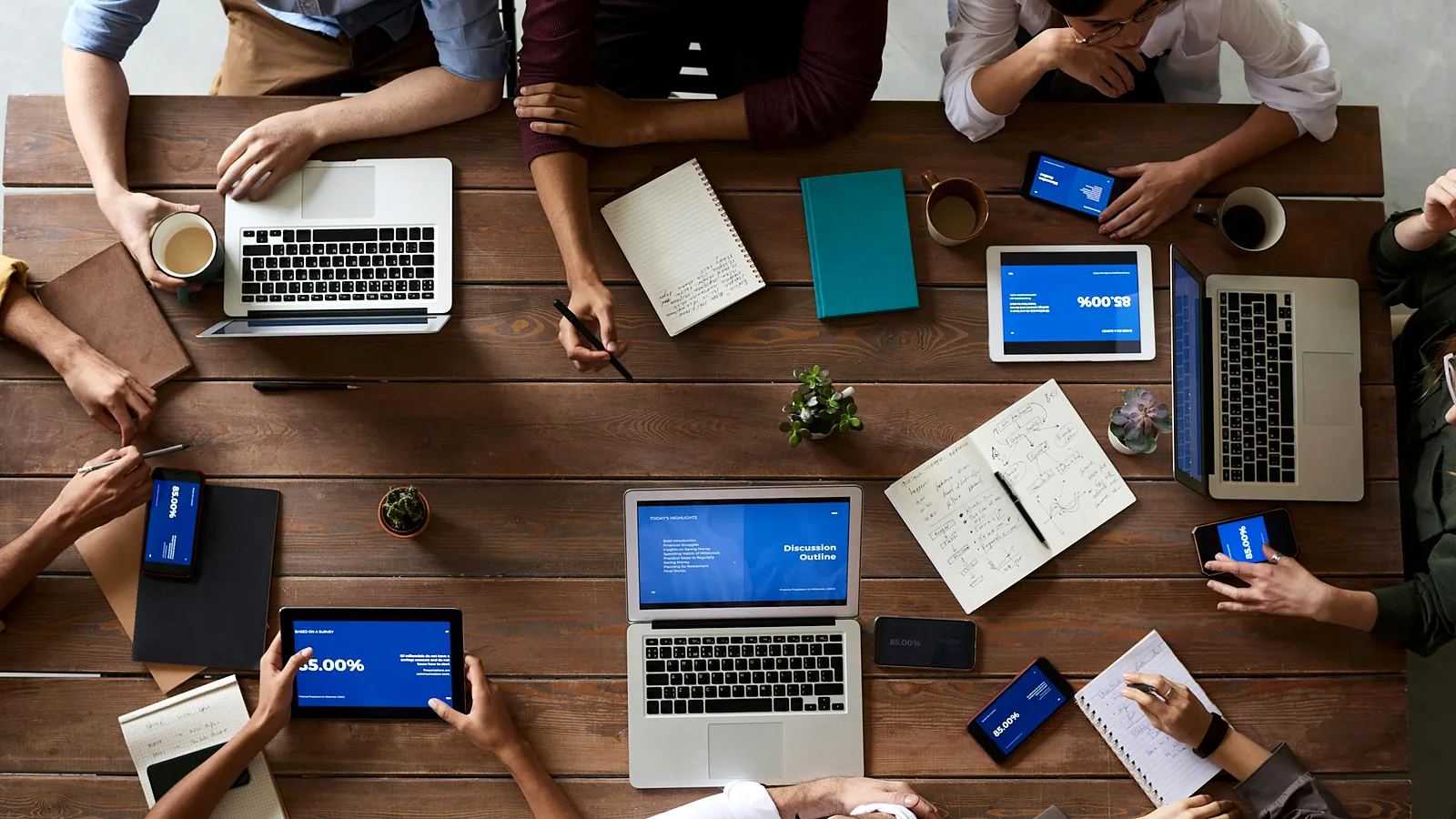 A team reviewing work together at a long table, seen from above