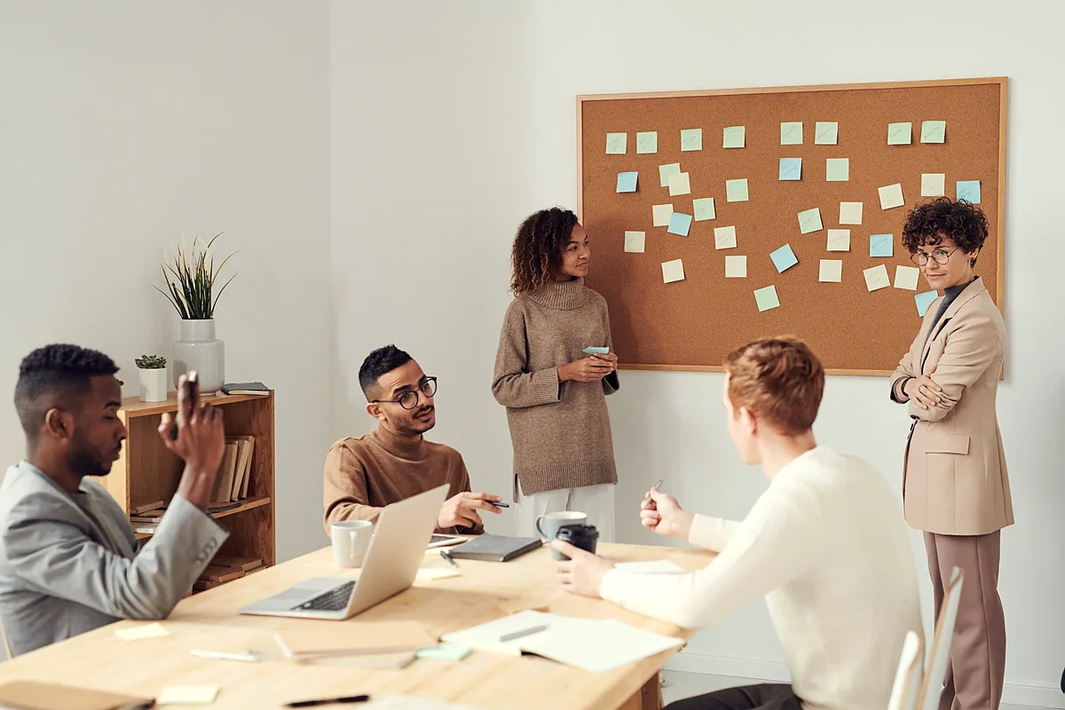 A team meeting around a table reviewing customer information