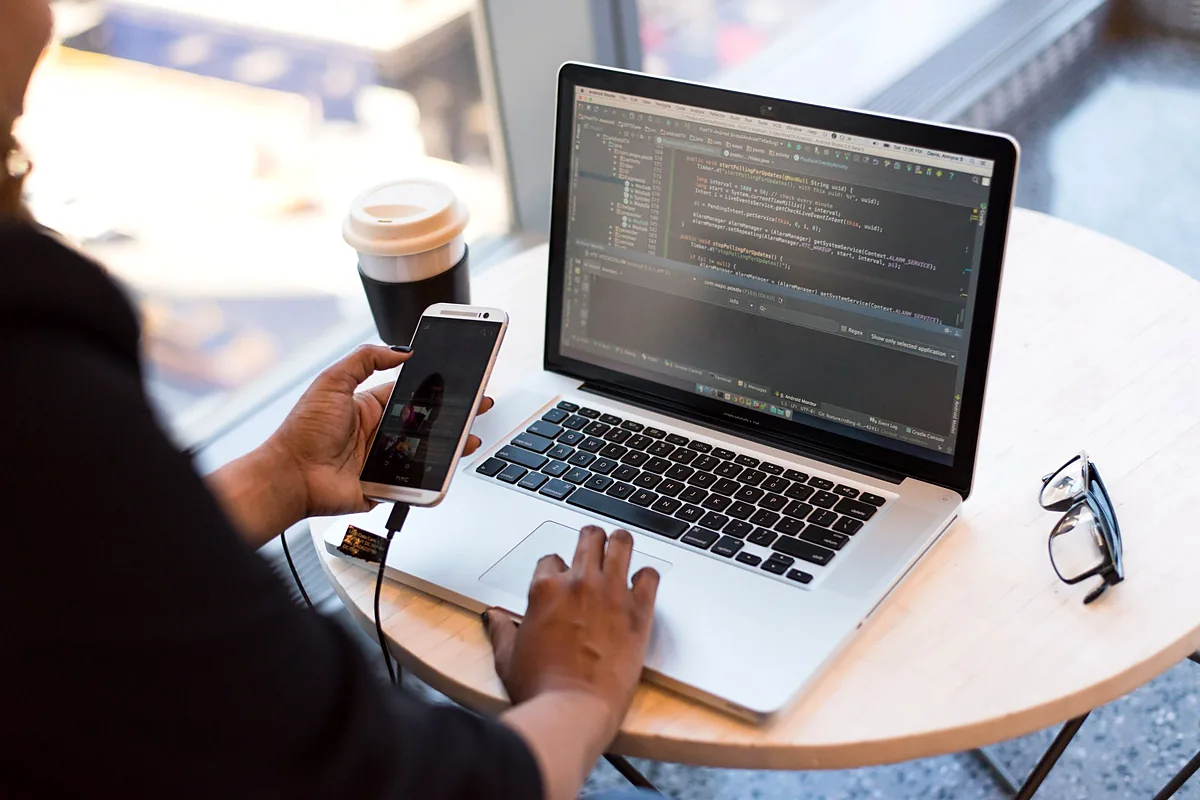 A workspace with a laptop by a window in a modern office